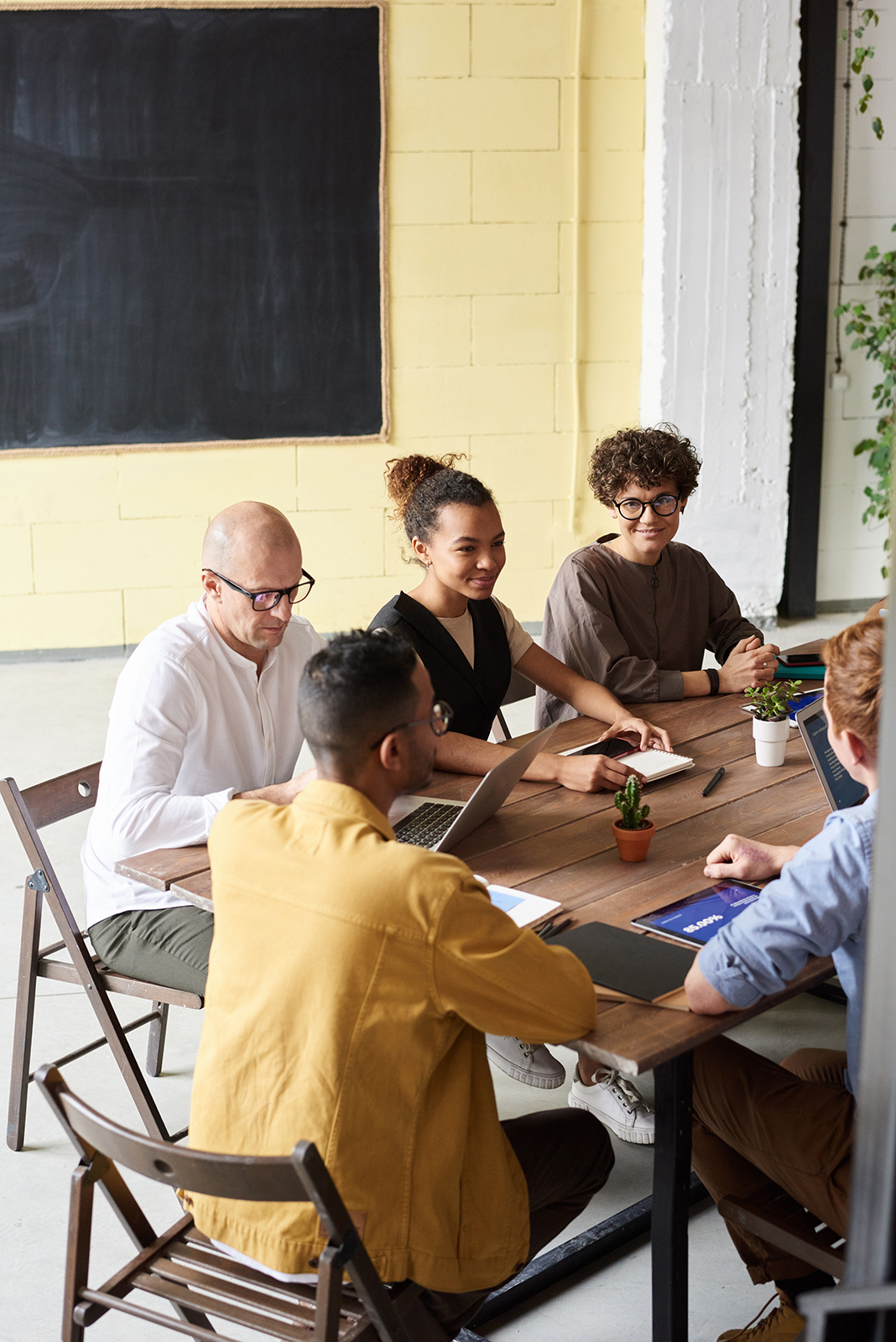 photo-of-people-leaning-on-wooden-table-3184614